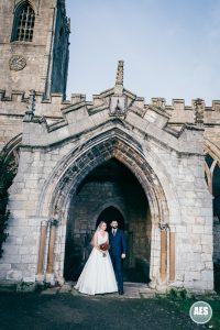 Bride and Groom in arch at St Mary and Martins Church in Blyth