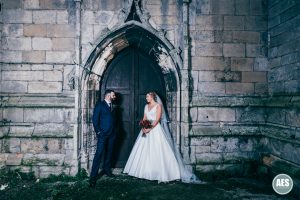 Bride and Groom inront of old door at St Mary and Martins Church in Blyth