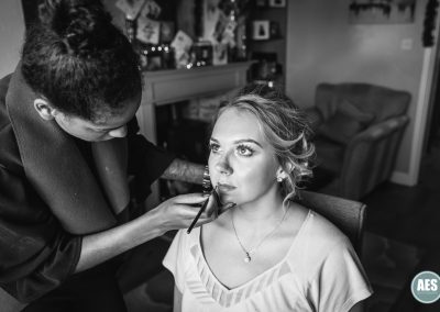 Bride getting her makeup done in the morning preparations