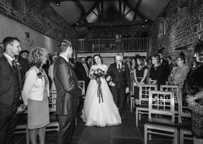 Walking down the aisle at The Ashes Country House wedding venue