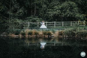 Bride and Groom lake reflection whitely hall hotel in Sheffield